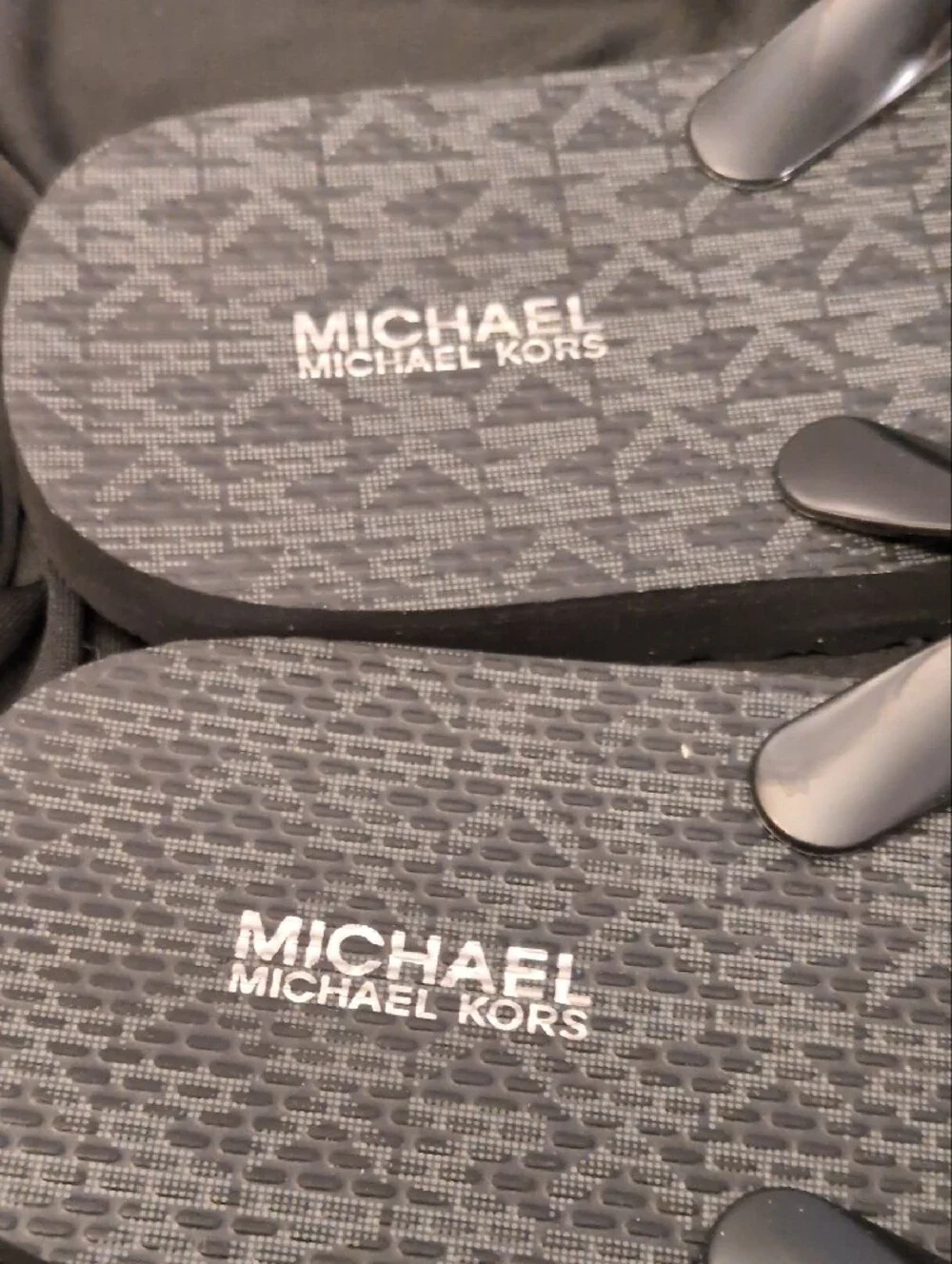 Michael Kors Black Logo Monogram Flip Flops with Silver MK Medallions.